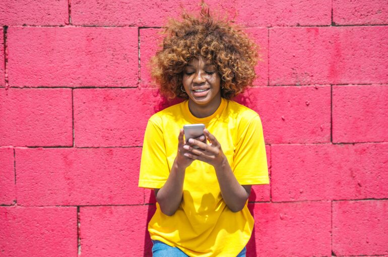 woman-in-yellow-shirt-holding-cellular-phone-3765114 (1)